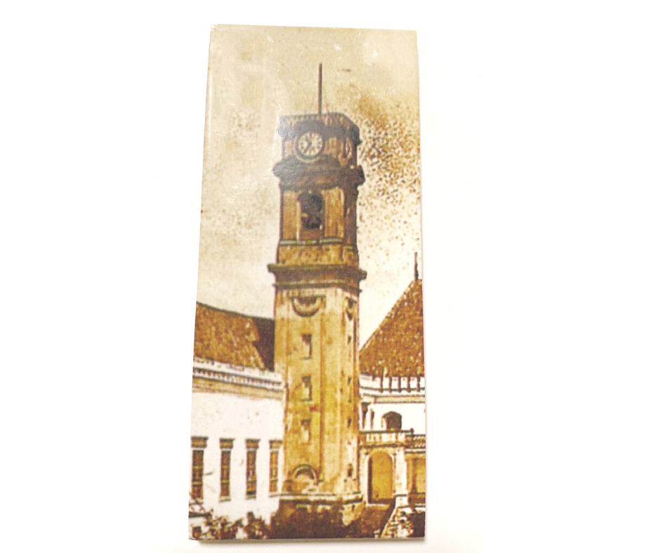 Caixa do abre-cápsulas com o formato da Torre da Universidade de Coimbra em metal dourado.